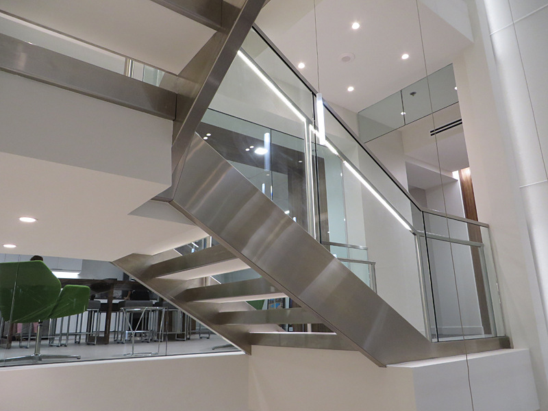 Stainless steel decorative metal stair featuring illuminated stainless steel railing.