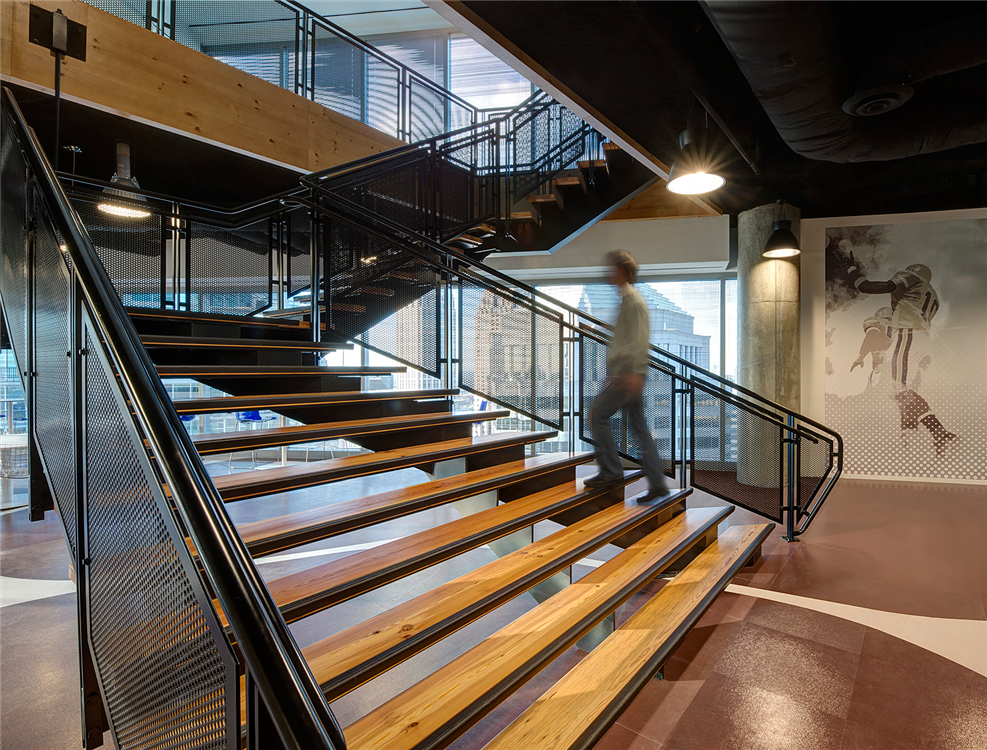 A beautiful wide flared decorative metal staircase by Couturier Iron Craft