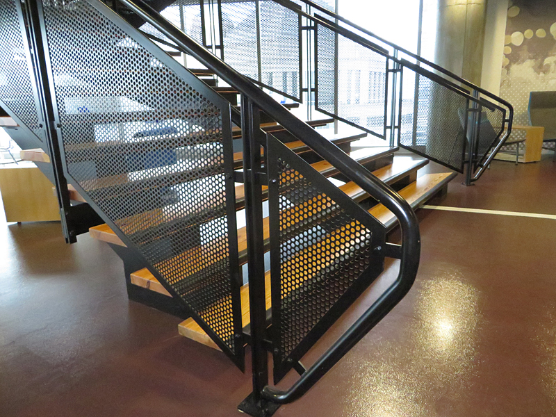 Open riser flared decorative metal stair by Couturier