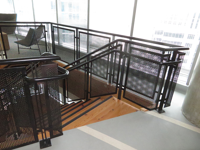 Decorative metal stair with perforated steel guardrails by couturier