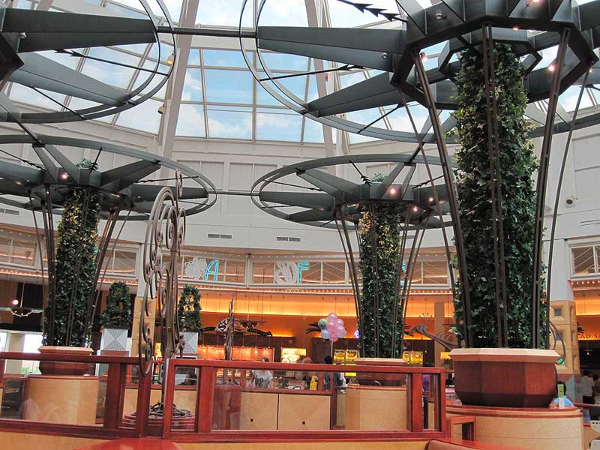 Large decorative iron trellises with round tops and plants growing up through the center