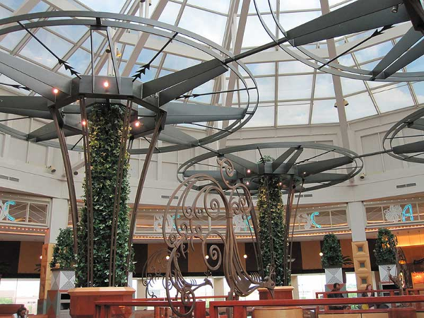 Large decorative iron trellises with round tops and plants growing up through the center at Somerset mall