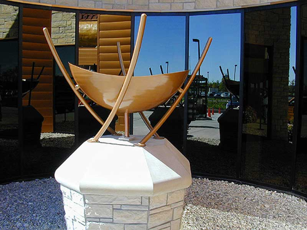 Custom made aluminum fire bowl sculpture is fueled by natural gas