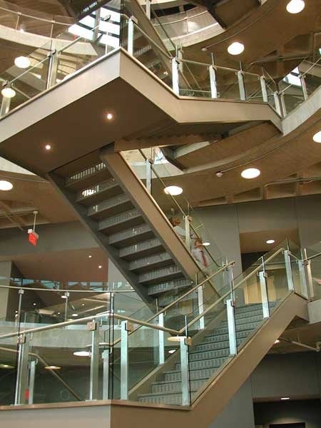 Decorative glazed railing with stainless steel balusters and top glass cap.