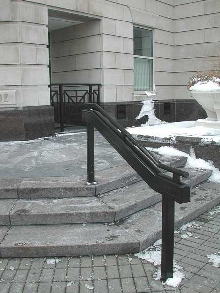 Aluminum hand railings at concrete steps.