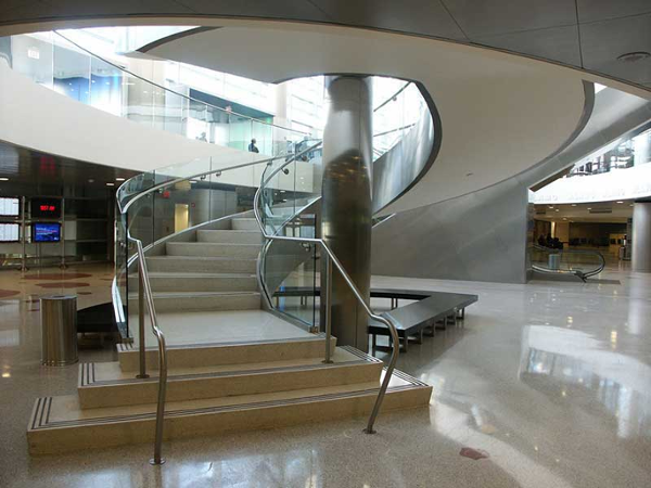Circular staircase with stainless steel and glass handrail at Fort Lauderdale Airport.