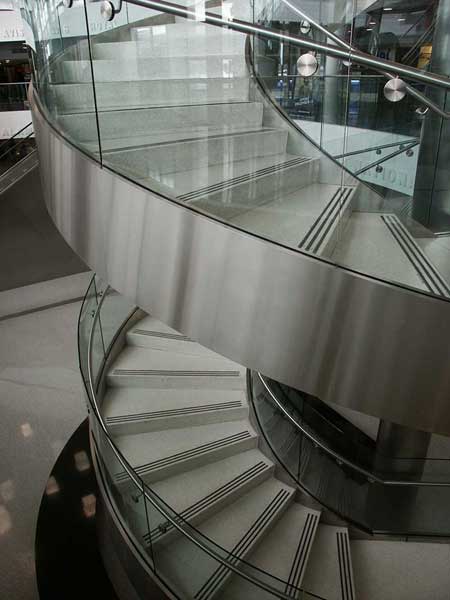 Multi flight stainless steel circular staircase at the Consolidated Car Rental Facility, Fort Lauderdale Airport.