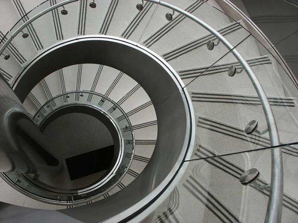 View of curved circular stair from top looking directly down the center of stairs.