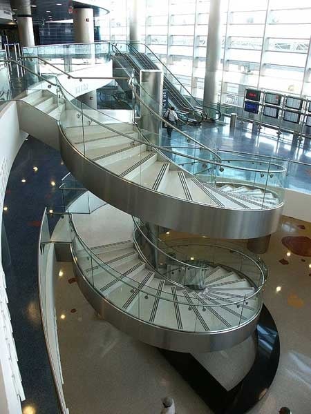 The curved lines of this stair invites you to skip the escalators.