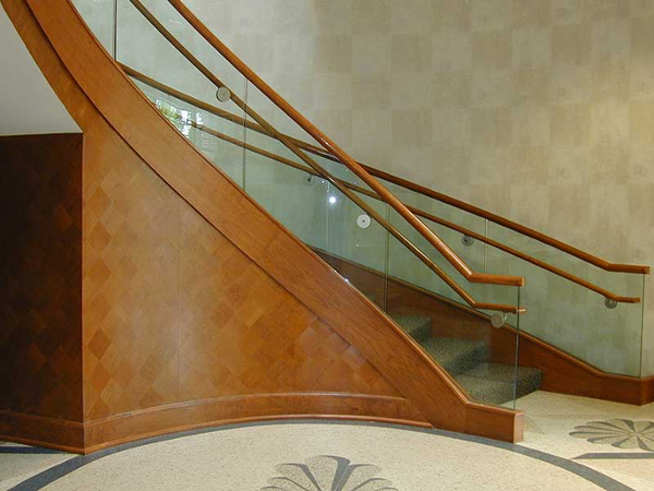 Beautiful curved stairway with wood and glass railings