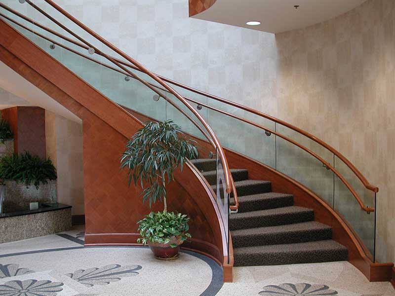 Wood curved stairway with carpet treads